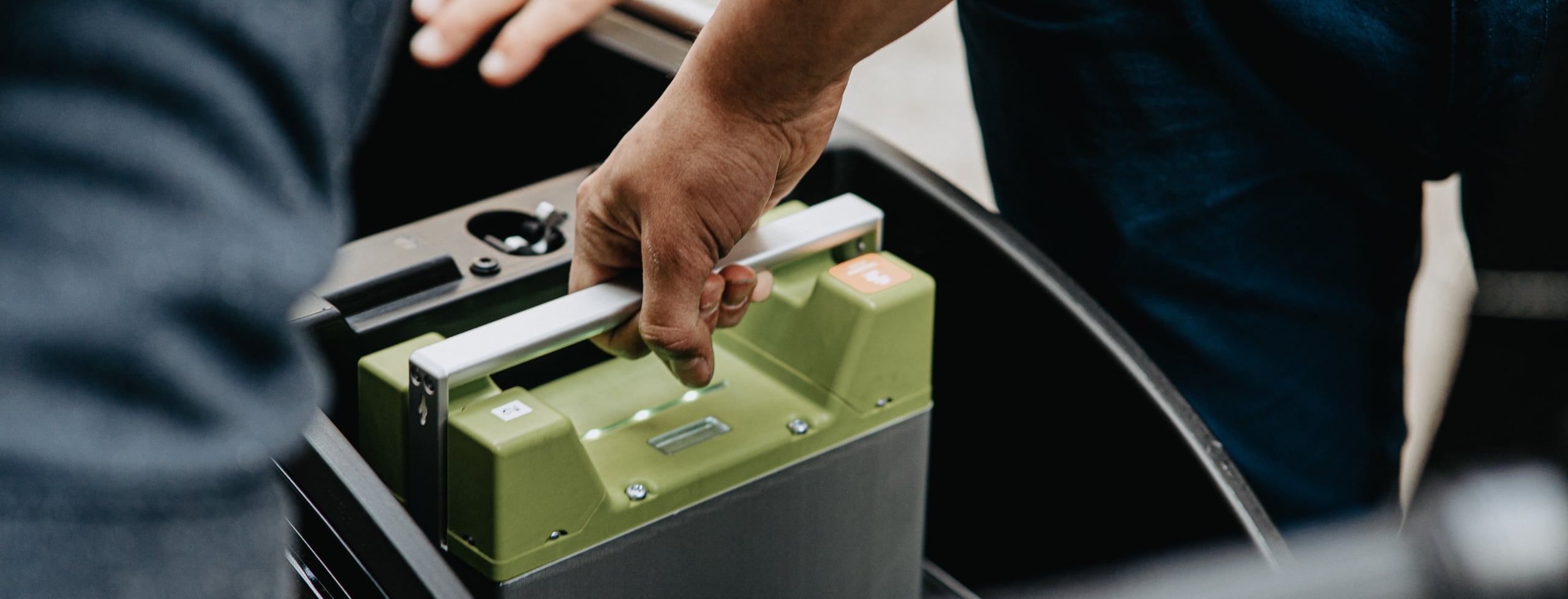 hand holding large battery and placing in storage area