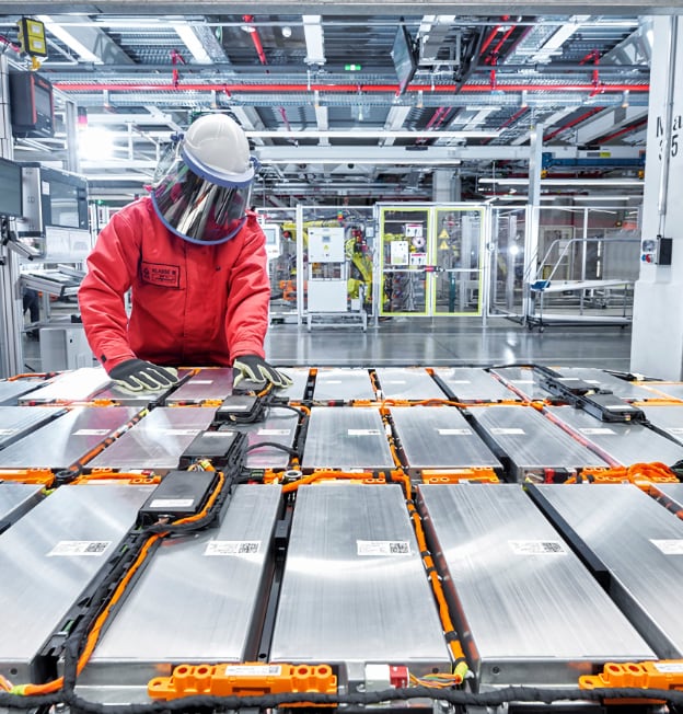 worker with helmet working on electronics in industrial clean room